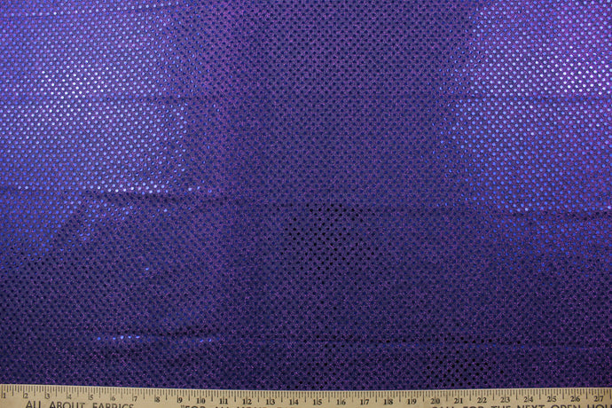 This semi-transparent tulle fabric is adorned with shimmering sequins, creating a beautiful and eye-catching effect in a vibrant purple color.  Perfect for special occasion apparel, dancewear, costumes, overlays, table tops, and decorations. 