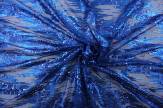Sequined in Royal Blue adds a touch of glamour to any outfit.  Made from a polyester net base, it is lightweight and comfortable to wear. The sequins create a stunning royal blue glimmer that will catch everyone's eye.  Perfect for adding sparkle to special occasion apparel, costumes, overlays, table tops, and decorations. 