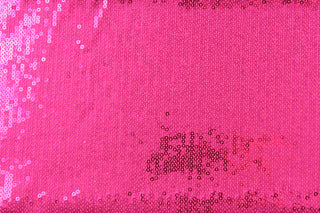 Achieve the perfect combination of comfort and style with our Sequined Shimmer in Hot Pink.  Made from a high-quality 8 way stretch polyester and lycra© base, this fabric provides flexibility and durability.  Perfect for adding sparkle to special occasion apparel, dancewear, costumes, overlays, table tops, and decorations. 