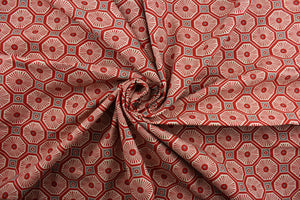  This multi-use fabric features a fun geometrical print featuring persimmon, light beige, and gray tones, making it perfect for a range of home décor projects.  Treated with a soil and stain repellant finish, this fabric is durable with a 100,000 double rub rating.  It can be used for several different statement projects including window accents (drapery, curtains and swags), toss pillows, headboards, bed skirts, duvet covers, upholstery, and more.