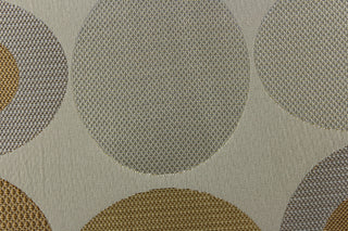 Geometric pattern of circles and ovals in gray, khaki and gold