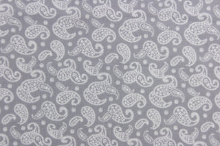This fabric features a paisley design in white set against a gray background. 