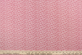 This fabric features a tiny floral design in red set against a white background.