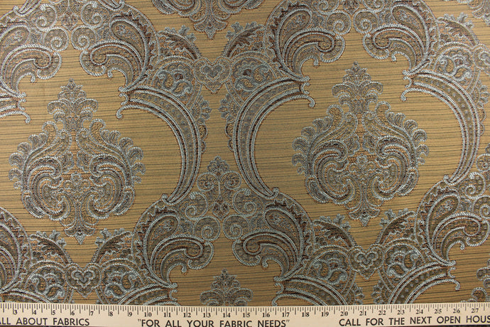 ornamental damask design in blue and brown  and hints of copper or dark gold on a gold tone  background