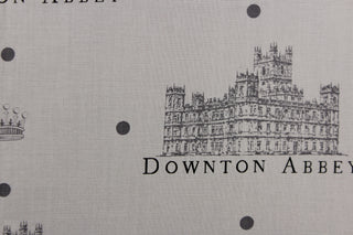  Featuring the Downton Abbey building and wording in gray and black with dark gray dots against a gray background. 