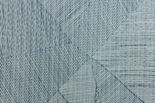  This jacquard features a geometric design in varying shades of blue .