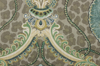 This unique fabric feature a medallion in varying shades of green, and  blue, with hints cream, gold and khaki against a taupe cheetah print. 