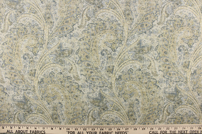  This fabric features a distressed paisley design in shades of blue, beige, hints of gray, yellow and off white. 