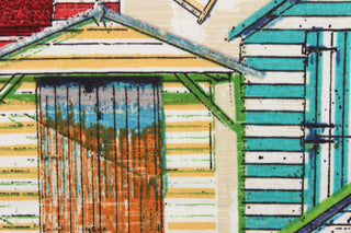 This fabric features small multi color beach huts nestled together near the ocean. Colors include orange, turquoise, green, yellow, tan and white.