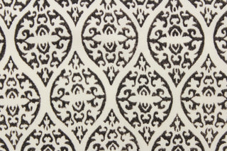  This outdoor fabric features a unique design in dark gray almost black against a white background.
