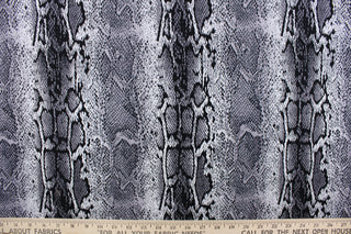  This 8 way stretch lycra fabric features a snakeskin design in black, gray and white