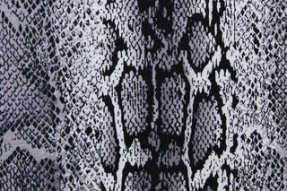  This 8 way stretch lycra fabric features a snakeskin design in black, gray and white
