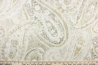 This fabric features a beautiful paisley design in beige, taupe, gray, and white.