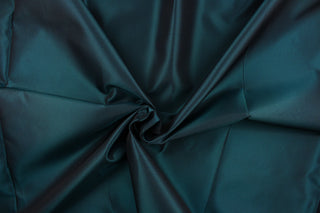 This taffeta fabric in iridescent in a deep teal