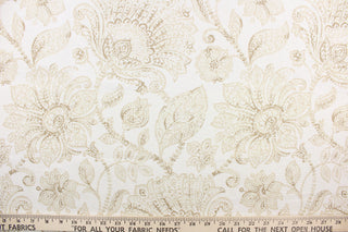This linen fabric features a floral design in beige or khaki and white. 