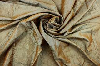 This taffeta fabric features a crinkle in iridescent gold aqua.