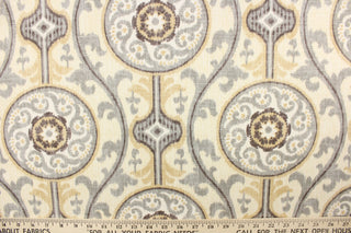 This fabric features a medallion print design that has an aged and distressed look.  Colors include slate gray, tan, charcoal and off white. 