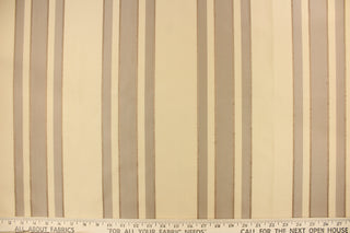 This fabric features a multi width stripe design in khaki, beige and bronze.