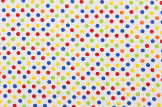 This fun colorful fabric features a polka dot design in red, green, orange, blue, and yellow against a white background.