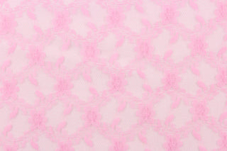 This lace features a woven floral design in a pink .