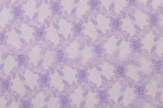 This lace features a woven floral design in purple. 