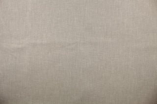 A linen fabric in a taupe gray with speckles of white .