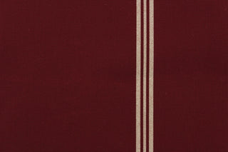  This fabric features a stripe design in burgundy and light beige. 