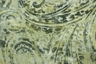 This fabric features a paisley design in gold, and varying shades of gray. 