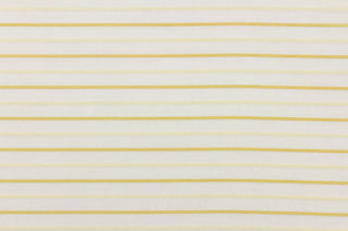This sheer fabric features a stripe design in gold and cream . 