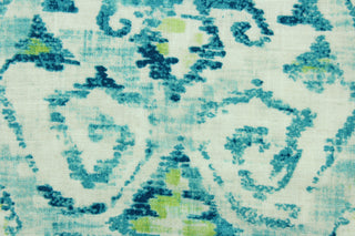  This fabric features an Aztec design in turquoise, lime green and white. 