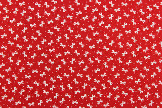This fabric features dainty white bows with polka dots on a solid red background.  It has a nice soft hand and would be great for quilting, crafting and home decor.  