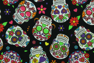 This cotton print fabric features white sugar skulls with bright colored floral detail.  Colors include black, white, blue, yellow, orange, purple, hot pink and green.  It has a nice soft hand and would be great for quilting, crafting and home décor.  
