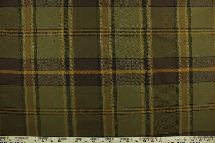  Tartan features a plaid design in brown, yellow, orange, green and black. It is durable and hard wearing and would be great for light duty upholstery, accent pillows and drapery. 