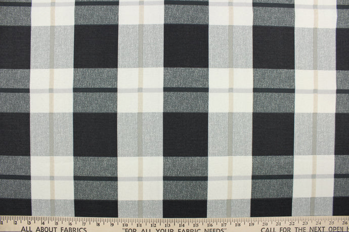 This fabric features a large plaid design in gray, black, khaki and off white.  It is perfect for outdoor settings or indoors in a sunny room.  It can withstand up to 500 hours of sunlight and is water and stain resistant and durable with 10,000 double rubs.  Perfect for porches, patios and pool side.  Uses include toss pillows, cushions, upholstery, tote bags and more.  