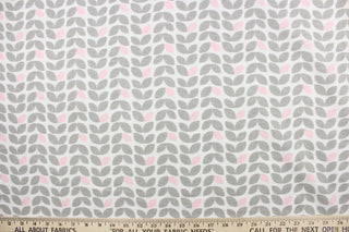 This printed flannel features leaves in gray and pink on a white background.  Uses include apparel, home decor and crafting.  This fabric has a soft workable feel. 