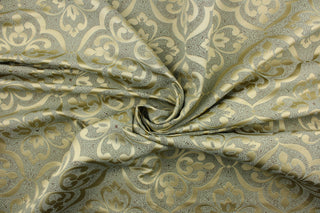 This jacquard fabric features a medallion design in shiny gold on a green background with accents of brown.  It is great for home decor such as multi-purpose upholstery, window treatments, pillows, duvet covers, tote bags and more.  It has a soft workable feel yet is stable and durable.