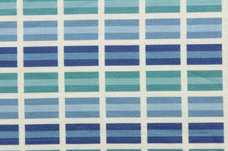 This fabric features a plaid design in shades of blue, green and dull white 