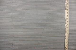 This sheer fabric features a stripe design  in silver against a black or dark blue  