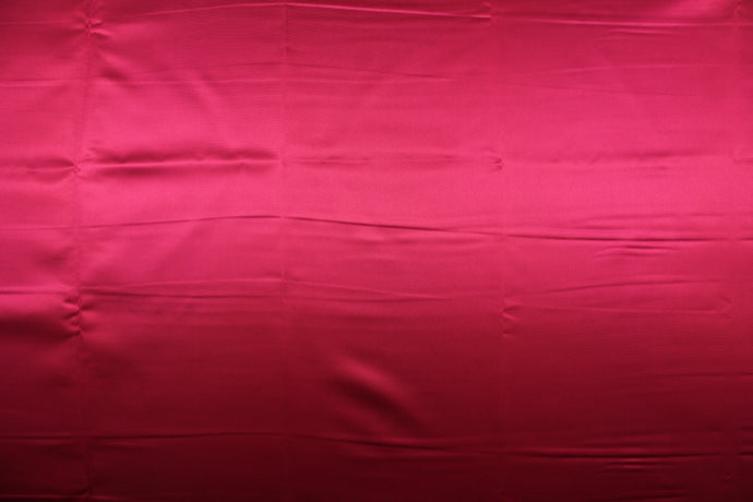 A beautiful satin fabric in a rich ruby red color.