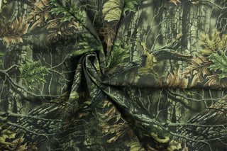 This camouflage fabric features realistic branches and leaves in various shades of green, brown and black against a hunter green background.  The fabric offers maximum concealment and is perfect for all open areas and is water repellant.  Uses include coveralls, pants, jackets, hats and bags.  We offer several different camouflage designs.