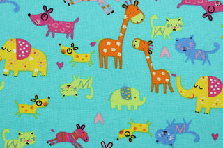  Menagerie is a bright animal print that features giraffes, elephants, zebras, dogs and cats. The versatile lightweight fabric is soft and easy to sew.  It would be great for quilting, crafting and sewing projects.  Colors included are orange, green, yellow, blue and pink.  We offer this print in other colors.