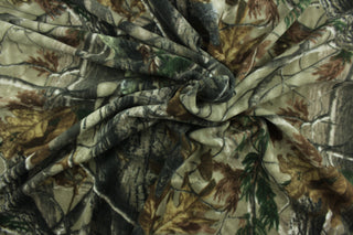 This ultra soft, medium weight printed fleece is the go to fabric for warmth.  The camouflage design features branches and leaves in the colors of green, gray, black and brown.  It is perfect for creating jackets, vests, scarves, gloves, throws, bedding and more! 