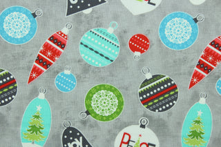 This cheerful holiday print features pretty ornaments outlined in a silver metallic overlay on a gray background.  The versatile lightweight fabric is soft and easy to sew.  It would be great for quilting, crafting and sewing projects.  Colors included are red, blue, green and turquoise.