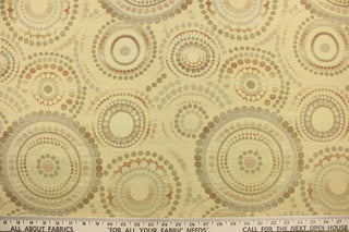 This contemporary geometric design features overlapping circles and dots in a brown, beige, green,  tan, taupe, and cream.