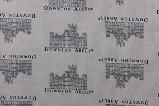  This quilting fabric features a Downtown Abbey print in gray .