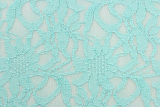 This lace features a floral design in a beautiful blue green with a stretch.