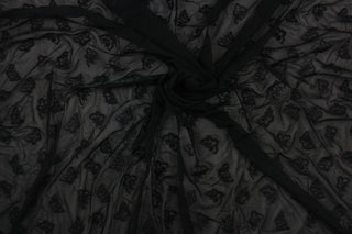 This lace features a butterfly design in black  with a stretch.
