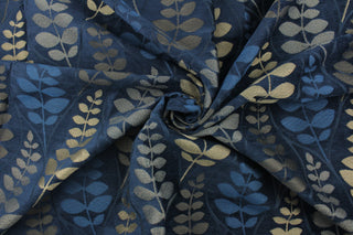 This fabric features a leave design in  gold tone set against a rich blue . 