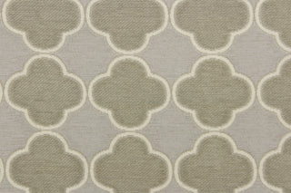 This fabric features a lattice quatrefoil design in taupe, gray and dull white. 