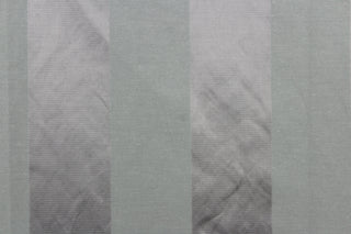 This fabric features a stripe design in gray with a slight shine. 